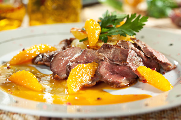 Duck Breast with Orange and Potato. Garnished with Orange Sauce and Parsley